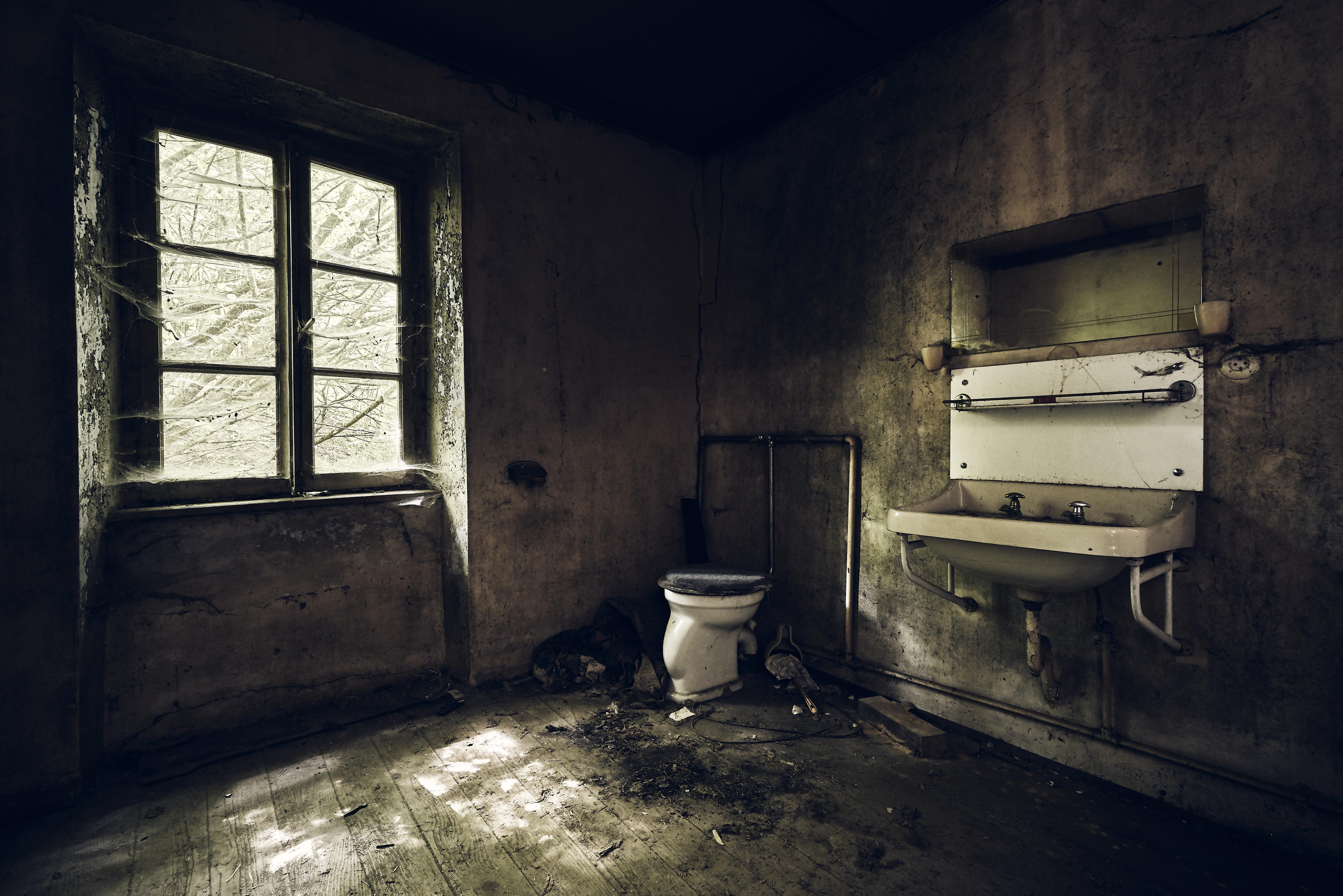 bathroom-with-sink-wall-covered-dirt-lights-abandoned-building (1).jpg
